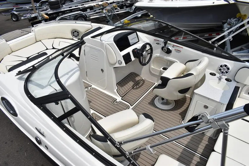 Slide: The Image of 2023 Stingray 231DC boat interior with modern seating and dashboard. - 12