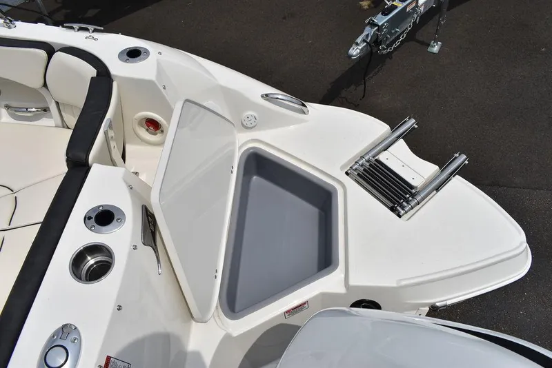 Slide: The Image of 2023 Stingray 231DC boat interior with storage compartment and ladder. - 14