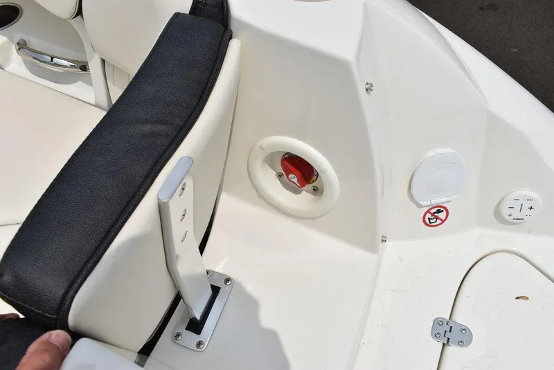 Slide: The Image of 2023 Stingray 231DC boat interior with seating and control panel. - 16