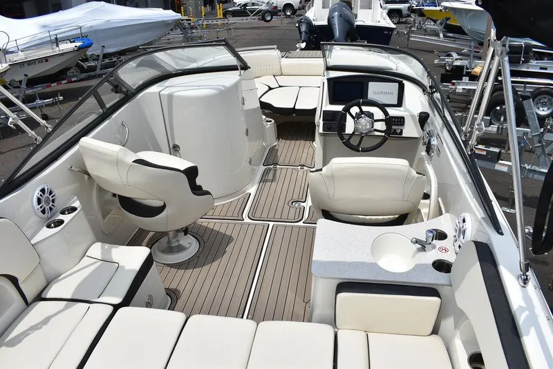 Slide: The Image of 2023 Stingray 231DC boat interior with seating, steering console, and deck. - 18