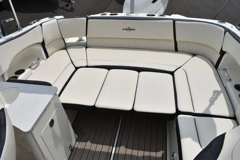 Slide: The Image of 2023 Stingray 231DC boat with spacious, cushioned seating area. - 19
