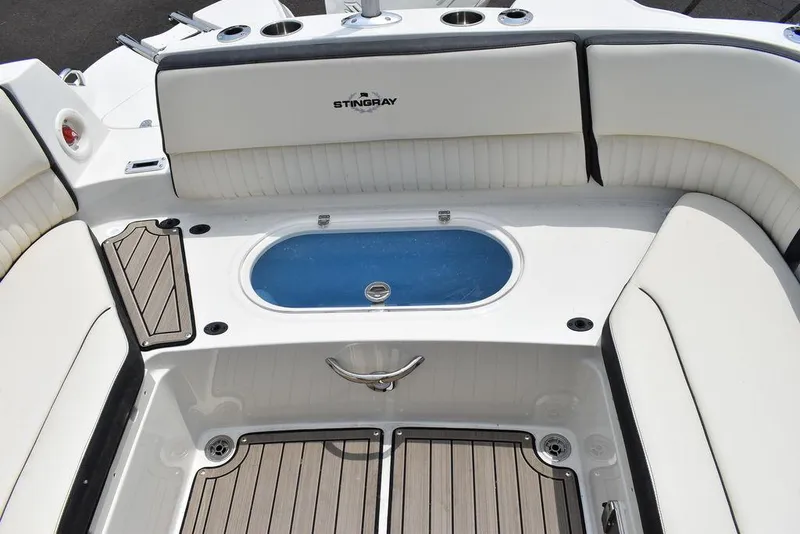 Slide: The Image of 2023 Stingray 231DC boat interior with seating and storage compartments. - 23