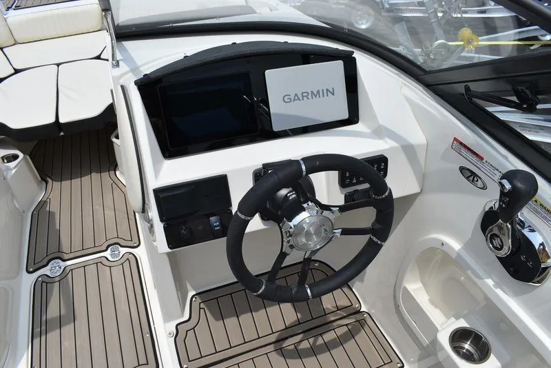 Slide: The Image of 2023 Stingray 231DC boat cockpit with Garmin navigation system and modern steering wheel. - 27