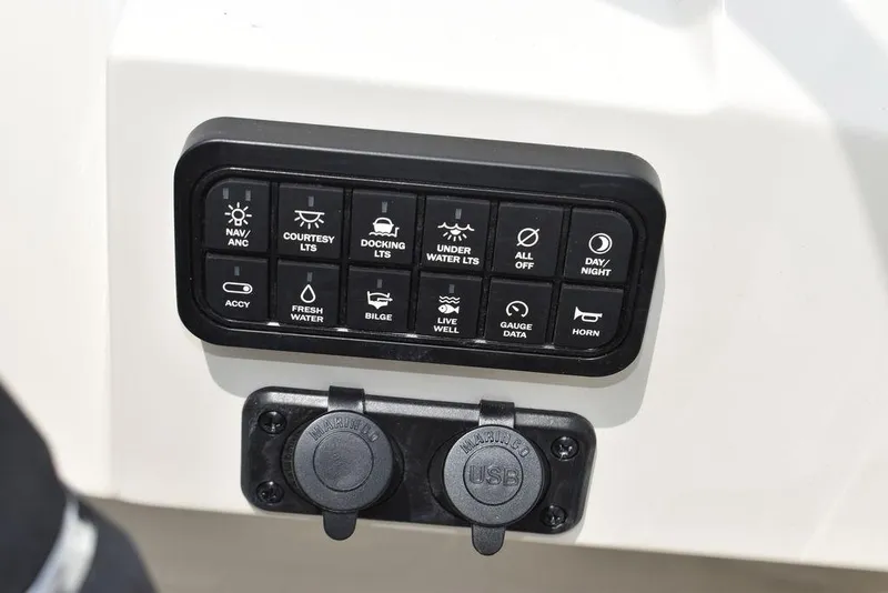 Slide: The Image of Control panel of a 2023 Stingray 231DC boat with various switches and USB ports. - 30