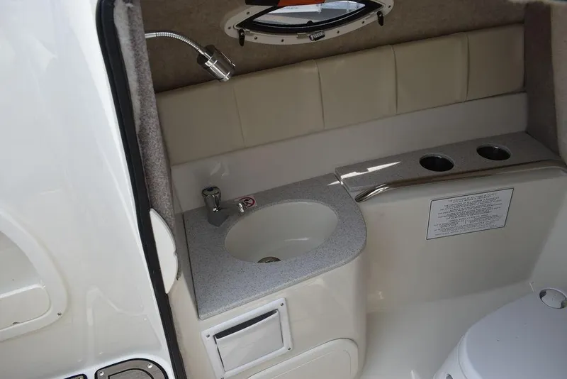 Slide: The Image of 2023 Stingray 231DC boat interior bathroom with sink and toilet. - 39
