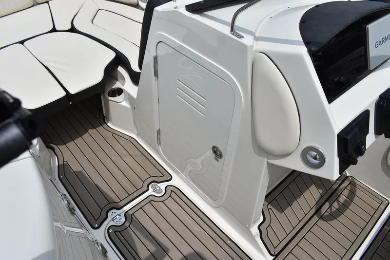 Slide: The Image of 2023 Stingray 231DC boat interior with cushioned seating and teak flooring. - 41