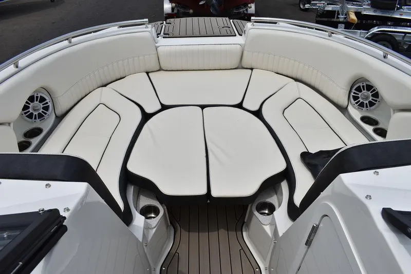 Slide: The Image of 2023 Stingray 231DC boat with spacious white cushioned seating area. - 46