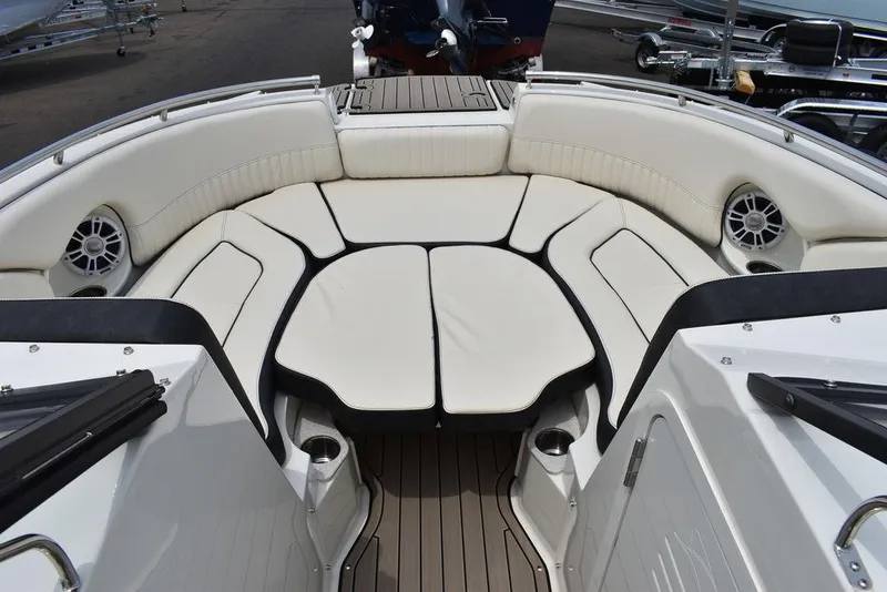 Slide: The Image of 2023 Stingray 231DC boat interior with white cushioned seating and speakers. - 47