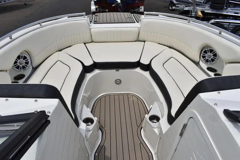 Slide: The Image of 2023 Stingray 231DC boat interior with cushioned seating and marine speakers. - 48