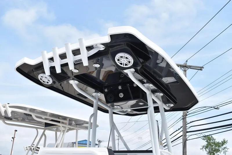 Slide: The Image of 2024 Blackfin 222CC boat T-top with speakers and rod holders. - 11