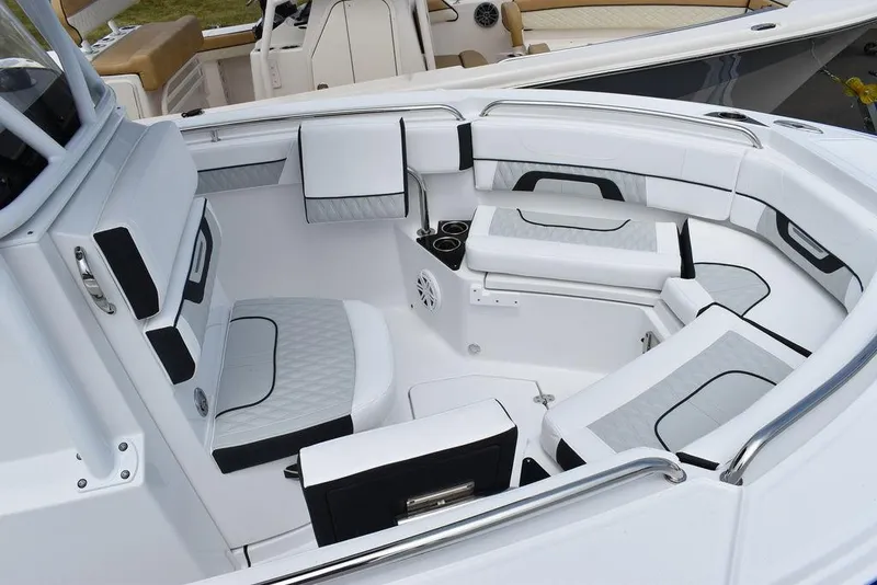 Slide: The Image of 2024 Blackfin 222CC boat interior with white cushioned seating and sleek design. - 14