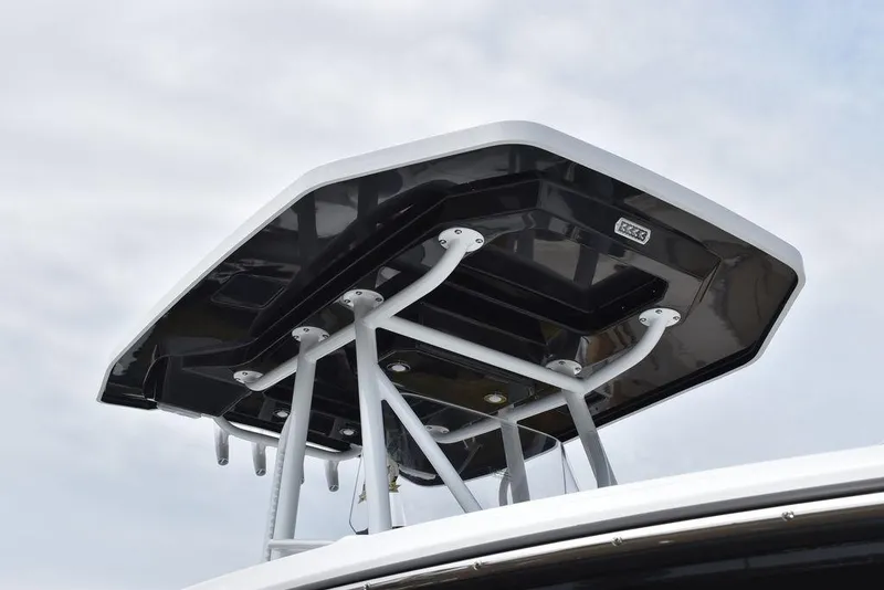 Slide: The Image of 2024 Blackfin 222CC boat T-top against cloudy sky. - 16