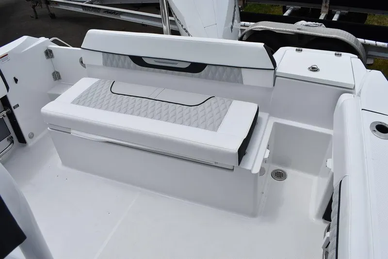 Slide: The Image of 2024 Blackfin 222CC boat interior with cushioned seating and storage. - 22