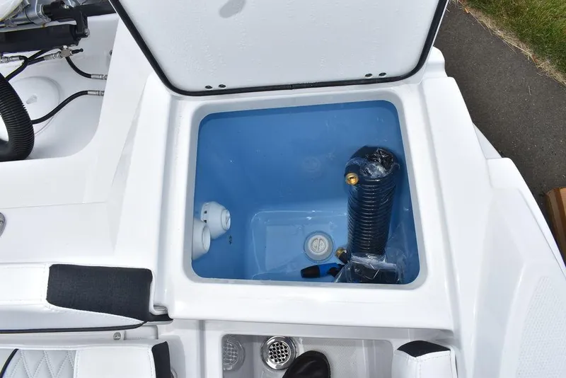 Slide: The Image of 2024 Blackfin 222CC boat storage compartment with blue interior and equipment. - 23
