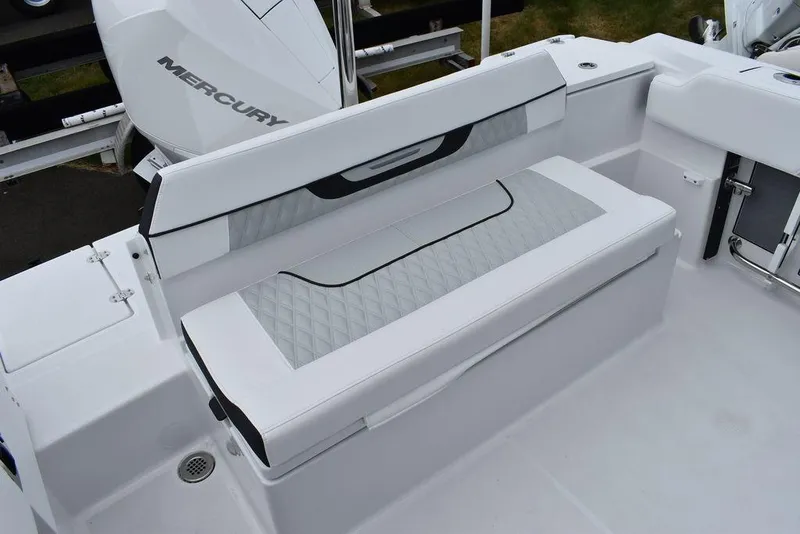 Slide: The Image of 2024 Blackfin 222CC boat seating area with Mercury engine in background. - 29
