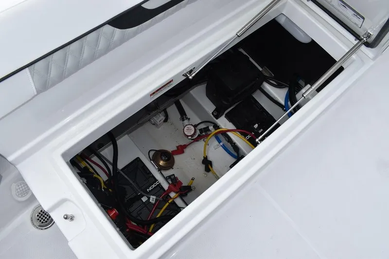Slide: The Image of 2024 Blackfin 222CC boat storage compartment with wiring and equipment. - 32