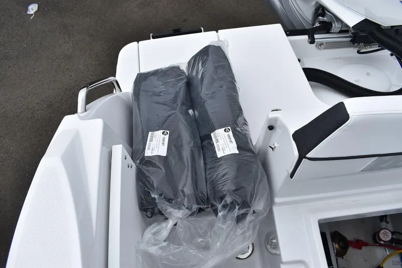 Slide: The Image of 2024 Blackfin 222CC boat interior with packaged accessories on deck. - 33