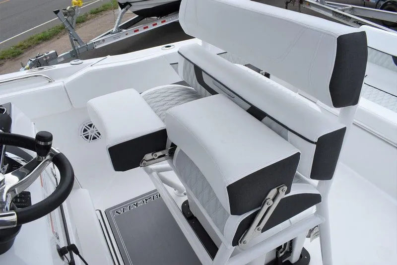 Slide: The Image of 2024 Blackfin 222CC boat interior with white seating and steering wheel. - 38