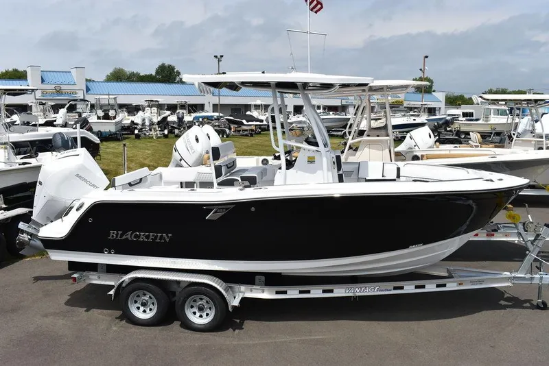 Slide: The Image of 2024 Blackfin 222CC boat on trailer at dealership, side view. - 4
