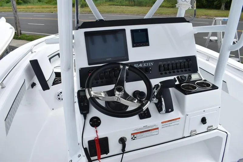 Slide: The Image of 2024 Blackfin 222CC boat console with steering wheel and electronic controls. - 41