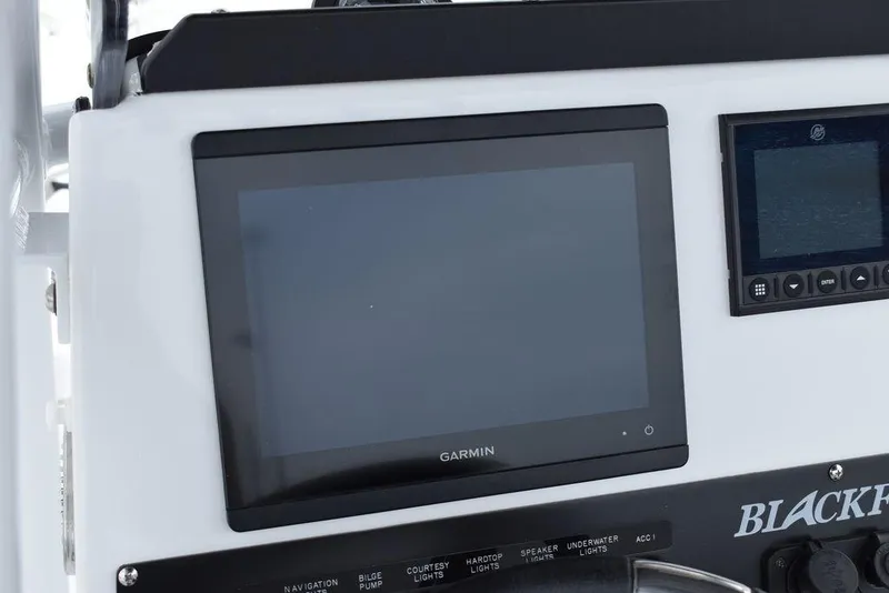 Slide: The Image of 2024 Blackfin 222CC boat dashboard with Garmin navigation display. - 42