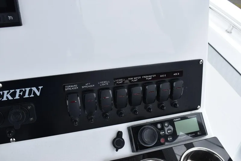 Slide: The Image of Control panel of 2024 Blackfin 222CC boat with switches and display. - 48