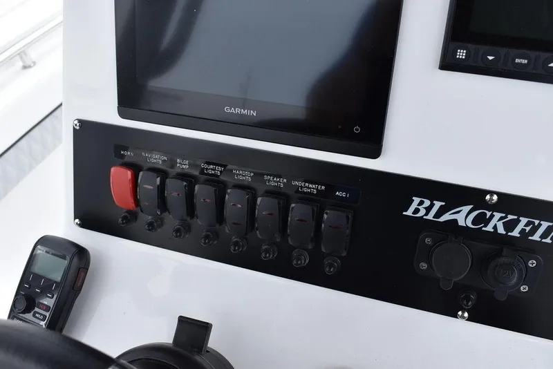 Slide: The Image of 2024 Blackfin 222CC boat dashboard with Garmin display and control panel. - 49