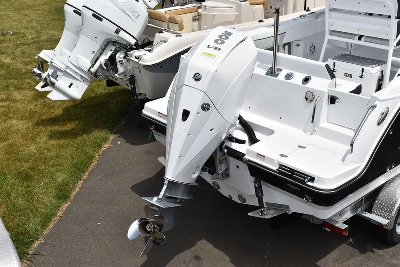 Slide: The Image of 2024 Blackfin 222CC boat with dual outboard engines on a trailer. - 5