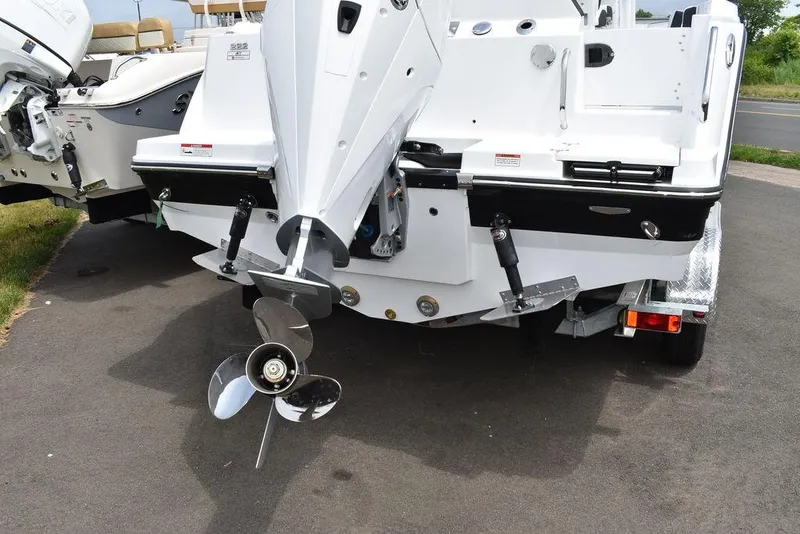 Slide: The Image of 2024 Blackfin 222CC boat stern with outboard motor and propeller on trailer. - 7