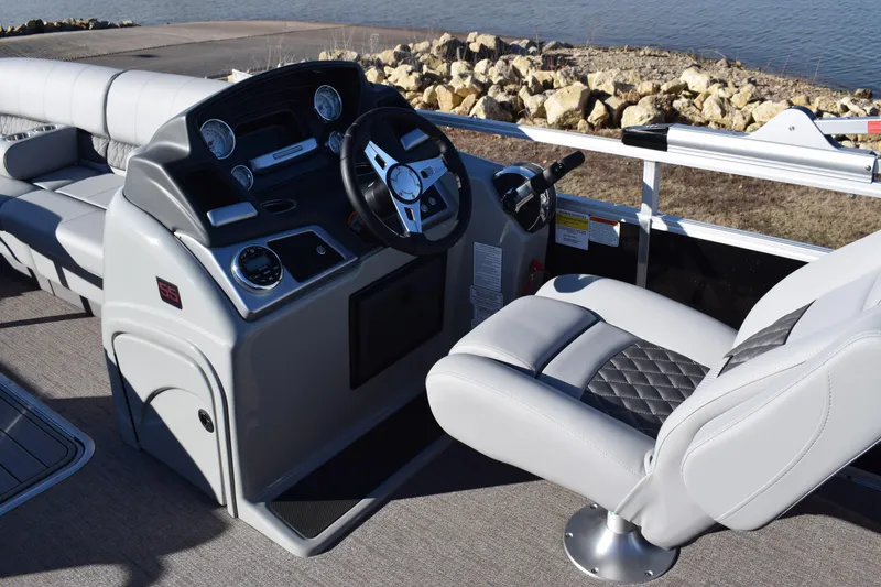 Slide: The Image of 2023 Ranger 223C boat interior with steering console and captain's chair. - 10
