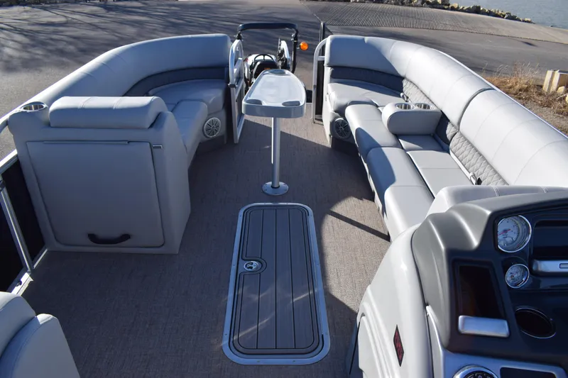 Slide: The Image of 2023 Ranger 223C pontoon boat interior with gray seating and central table. - 11