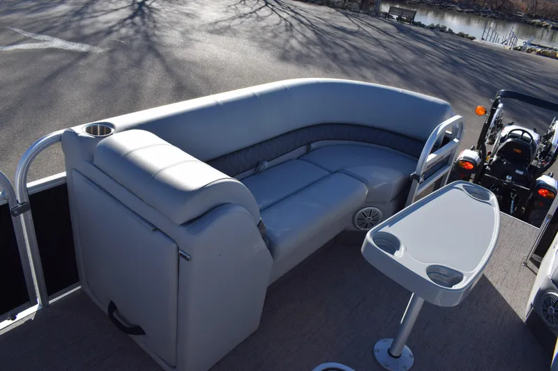 Slide: The Image of 2023 Ranger 223C pontoon boat with gray seating and table. - 12