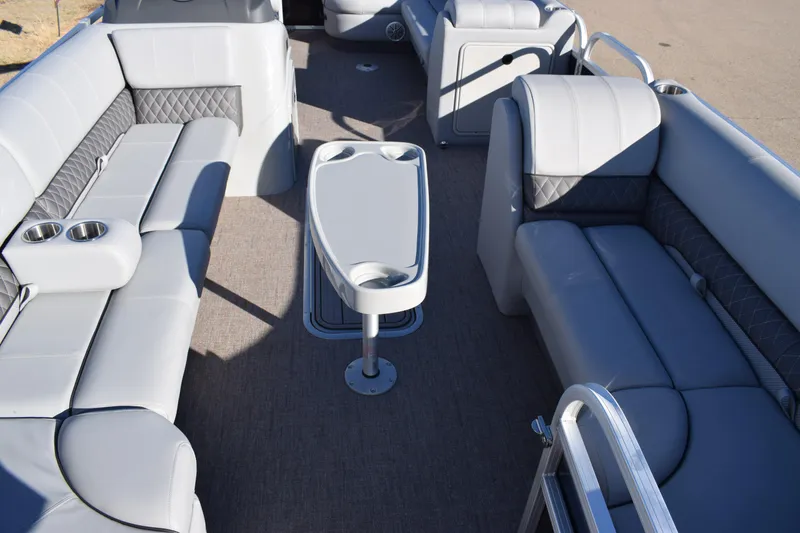 Slide: The Image of 2023 Ranger 223C boat interior with gray seating and central table. - 14