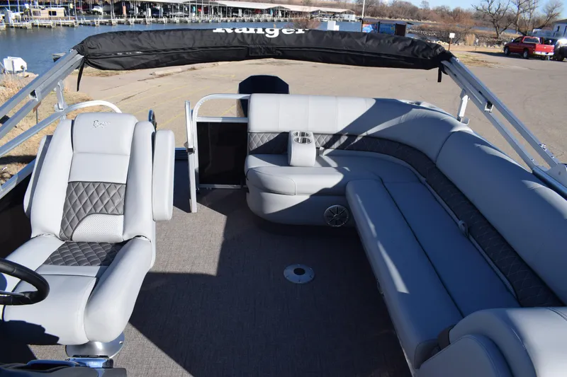Slide: The Image of 2023 Ranger 223C boat interior with gray seating and steering console. - 16