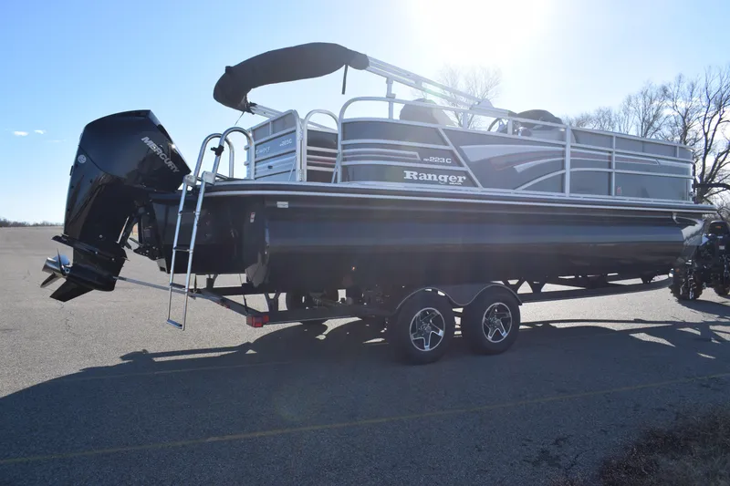 Slide: The Image of 2023 Ranger 223C pontoon boat on a trailer, side view. - 5