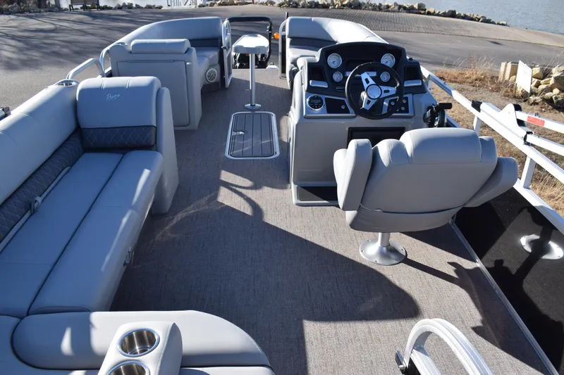 Slide: The Image of 2023 Ranger 223C pontoon boat interior with plush seating and modern helm. - 6