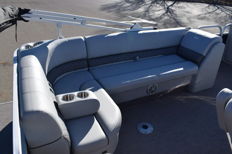 Slide: The Image of 2023 Ranger 223C boat with spacious, cushioned seating and built-in cup holders. - 7