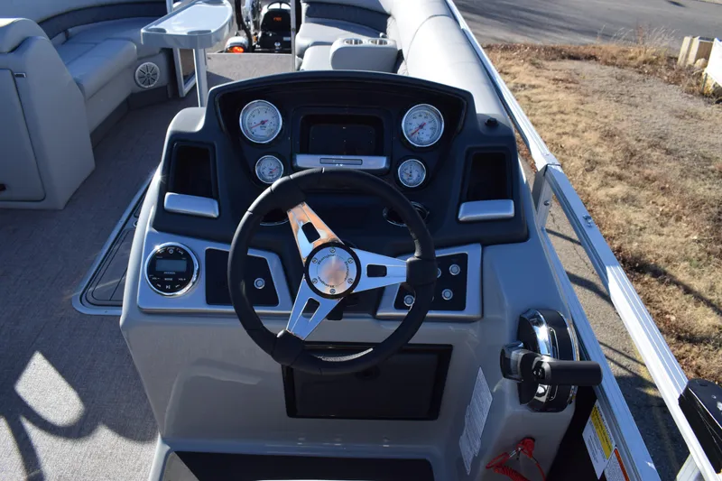 Slide: The Image of 2023 Ranger 223C boat dashboard with steering wheel and gauges. - 8