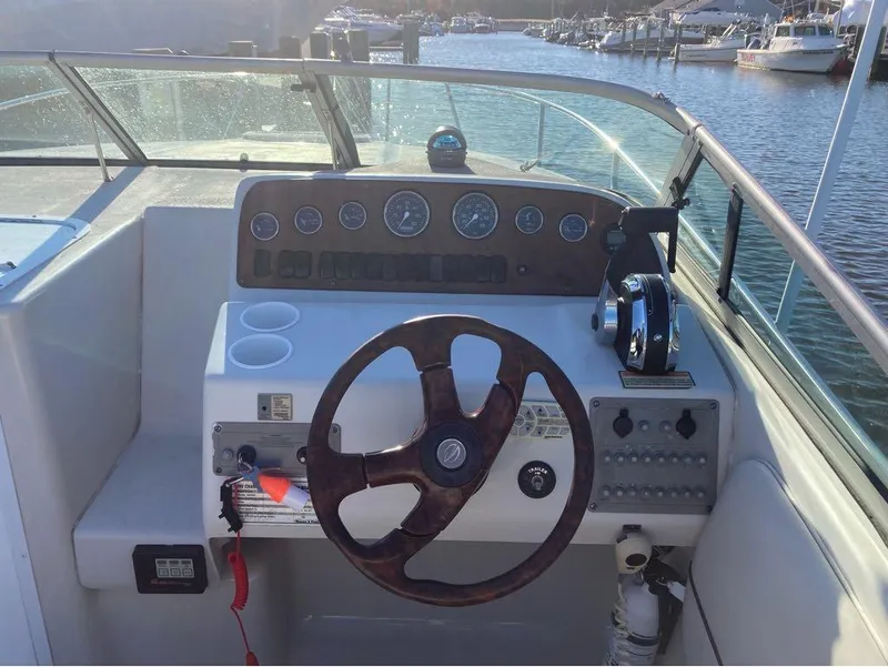 Slide: The Image of Crownline 268 2000 boat dashboard with steering wheel and control panel at marina. - 12