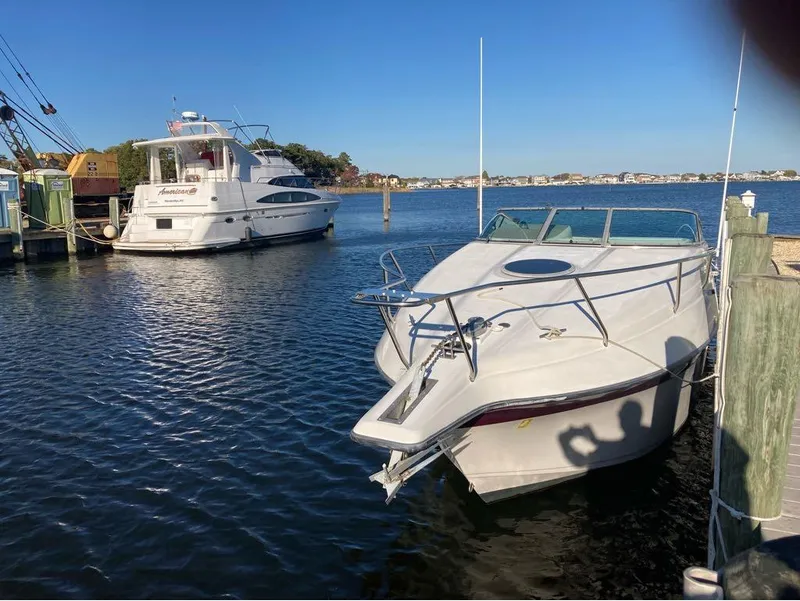 Slide: The Image of 2000 Crownline 268 boat docked in a marina on a sunny day. - 14