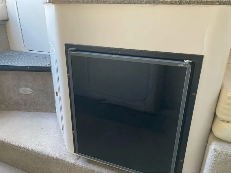 Slide: The Image of Interior of 2000 Crownline 268 boat featuring a Norcold refrigerator. - 4