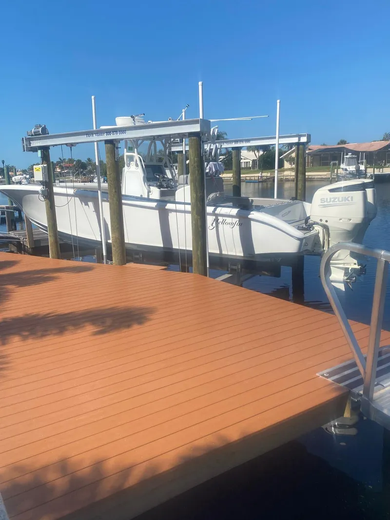 Slide: The Image of 2005 Yellowfin 31 boat docked at marina under clear blue sky. - 10