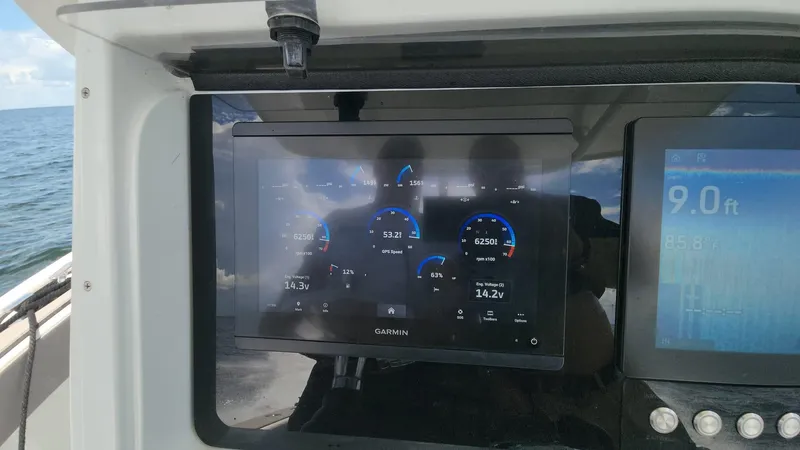 Slide: The Image of Garmin marine display on 2005 Yellowfin 31 boat dashboard, showing navigation data. - 15