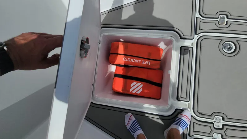 Slide: The Image of Storage compartment on 2005 Yellowfin 31 boat with life jackets inside. - 17
