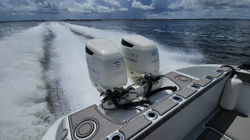 Slide: The Image of 2005 Yellowfin 31 boat with dual Suzuki outboard engines cruising on open water. - 2