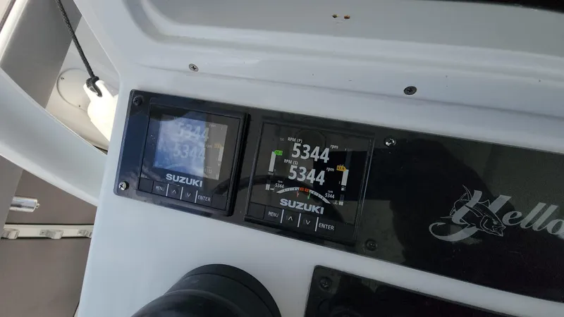 Slide: The Image of Suzuki engine displays on a 2005 Yellowfin 31 boat dashboard. - 21