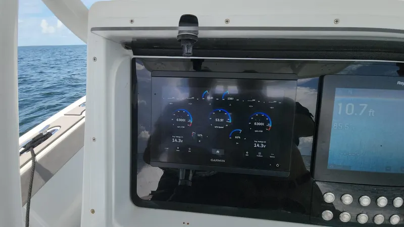 Slide: The Image of Dashboard of a 2005 Yellowfin 31 boat with digital gauges and ocean view. - 22