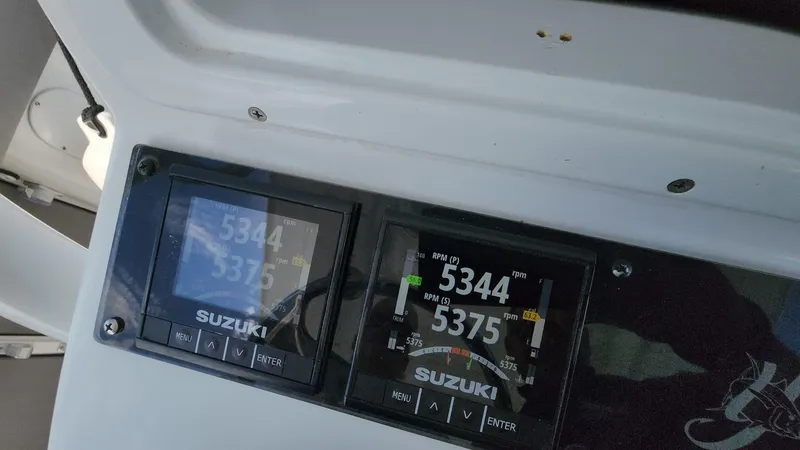 Slide: The Image of Suzuki engine displays on a 2005 Yellowfin 31 boat dashboard. - 24