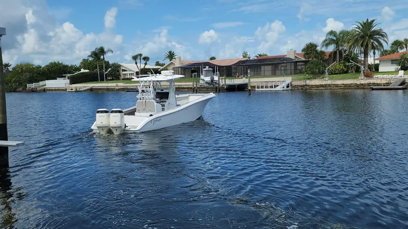 Slide: The Image of 2005 Yellowfin 31 boat cruising on a calm, scenic waterway. - 25