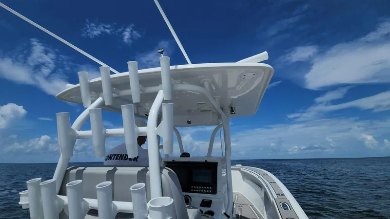 Slide: The Image of 2005 Yellowfin 31 boat on open water under clear blue sky. - 27